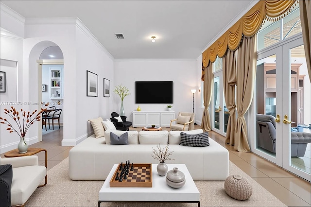 7761 SW 122nd Ave, Miami, FL 33183 - living room featuring light tile patterned flooring, arched walkways, french doors, crown molding, and baseboards