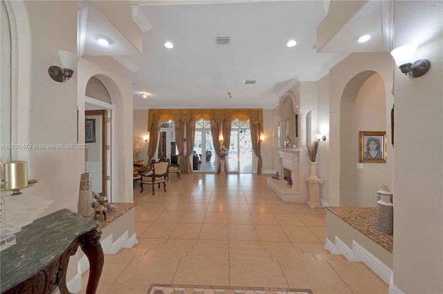 7761 SW 122nd Ave, Miami, FL 33183 - hallway with arched walkways, light tile patterned floors, recessed lighting, crown molding, and baseboards