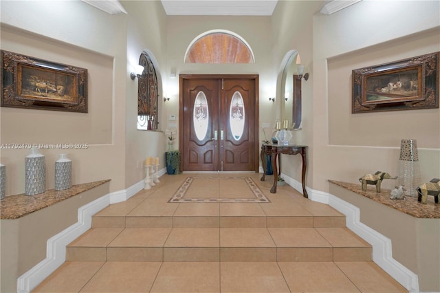 7761 SW 122nd Ave, Miami, FL 33183 - tiled foyer entrance with baseboards, arched walkways, and a towering ceiling