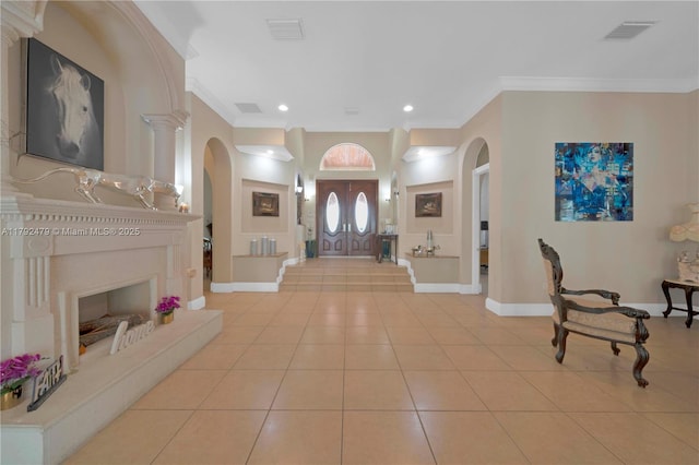 7761 SW 122nd Ave, Miami, FL 33183 - entrance foyer with arched walkways, ornamental molding, light tile patterned floors, baseboards, and recessed lighting