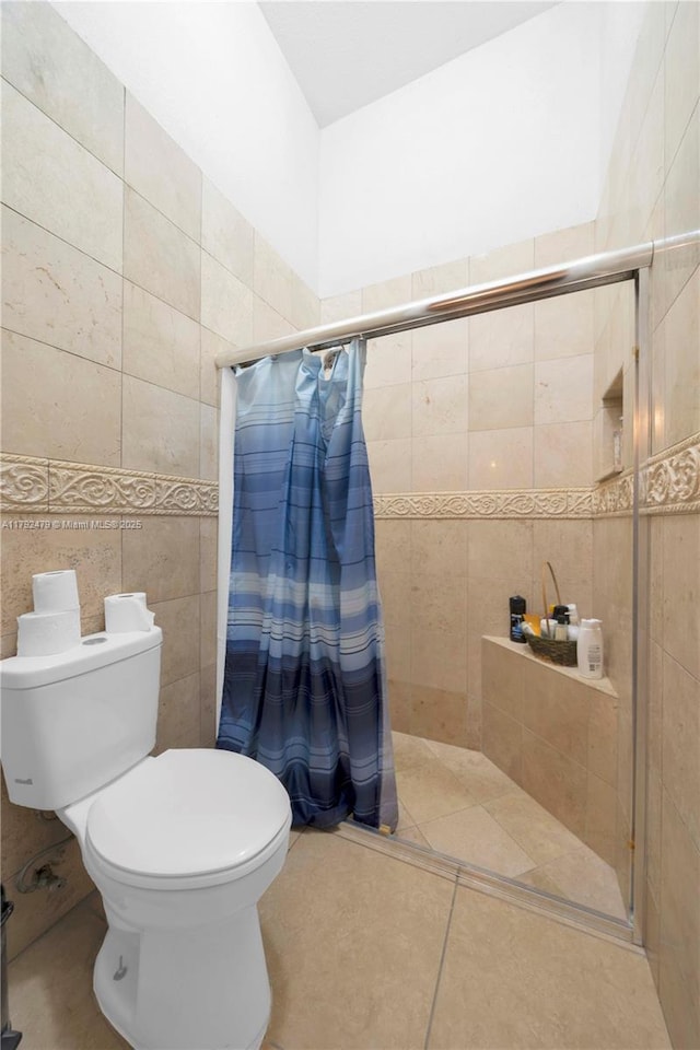 7761 SW 122nd Ave, Miami, FL 33183 - bathroom with a shower stall, tile patterned flooring, toilet, and tile walls