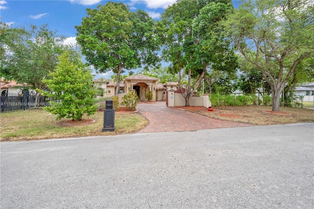 7761 SW 122nd Ave, Miami, FL 33183 - mediterranean / spanish-style house featuring fence, decorative driveway, stucco siding, and a tile roof