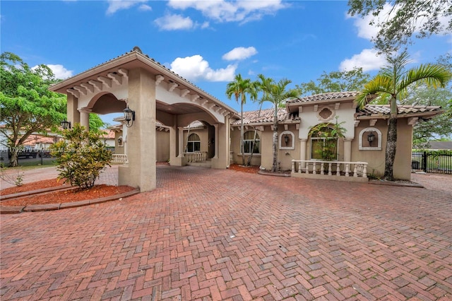 7761 SW 122nd Ave, Miami, FL 33183 - back of house featuring stucco siding, fence, decorative driveway, and a tile roof