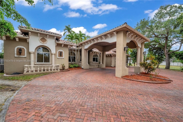 7761 SW 122nd Ave, Miami, FL 33183 - rear view of property with stucco siding, curved driveway, and a tile roof