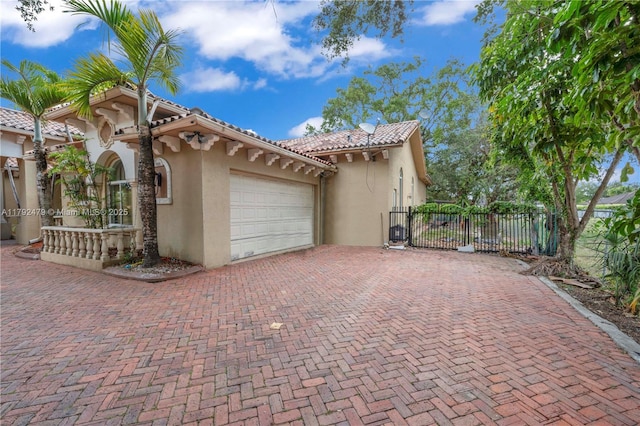 7761 SW 122nd Ave, Miami, FL 33183 - view of property exterior with stucco siding, an attached garage, fence, and decorative driveway