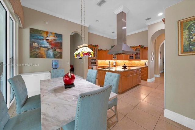 7761 SW 122nd Ave, Miami, FL 33183 - dining area with arched walkways, light tile patterned floors, baseboards, ornamental molding, and recessed lighting