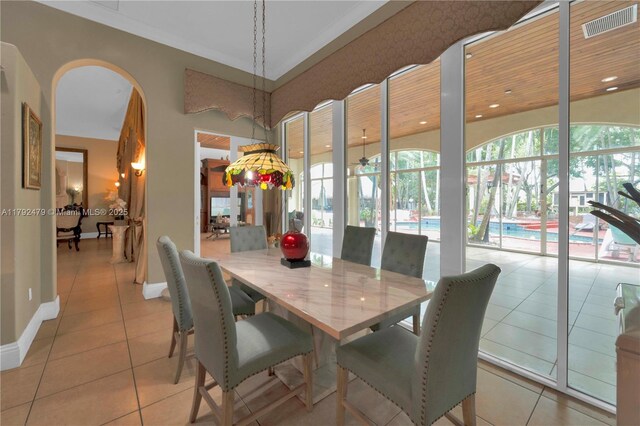 7761 SW 122nd Ave, Miami, FL 33183 - dining space featuring light tile patterned flooring, baseboards, arched walkways, and recessed lighting
