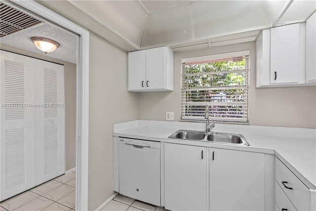 kitchen with white cabinets, a sink, dishwasher, light countertops, and visible vents