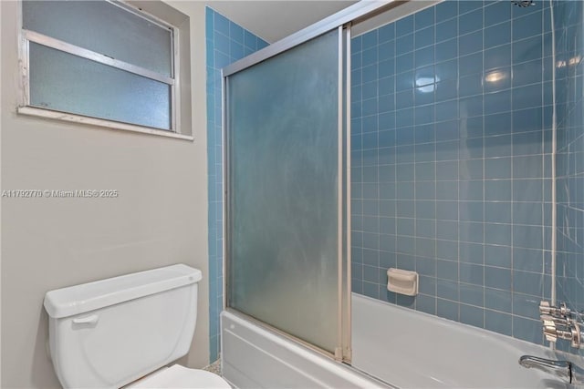 bathroom featuring shower / bath combination with glass door and toilet