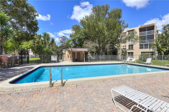 pool featuring fence and a patio area