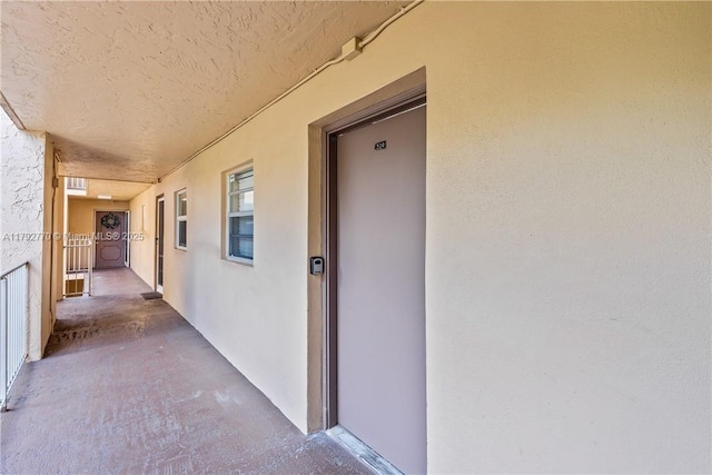 view of exterior entry with stucco siding
