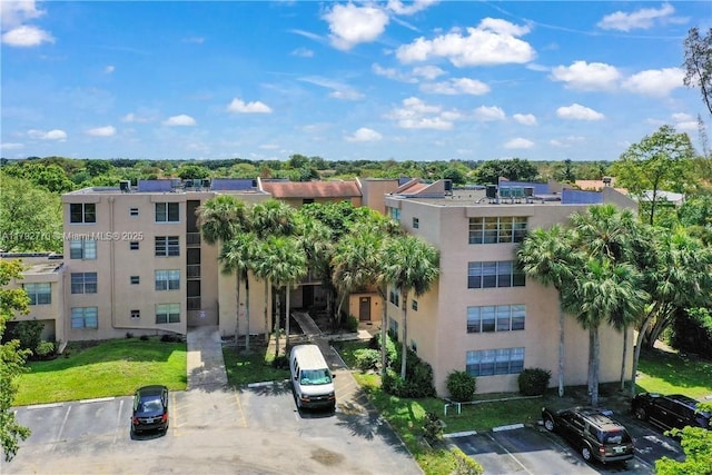 view of property featuring uncovered parking