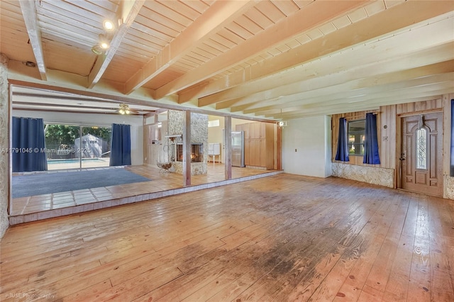 spare room featuring beamed ceiling, ceiling fan, and hardwood / wood-style flooring