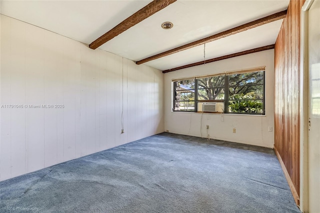 carpeted empty room featuring wooden walls, beam ceiling, and cooling unit