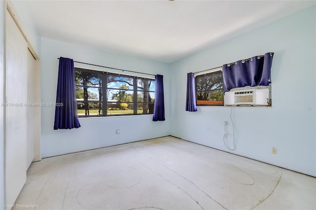 unfurnished room featuring cooling unit and concrete flooring