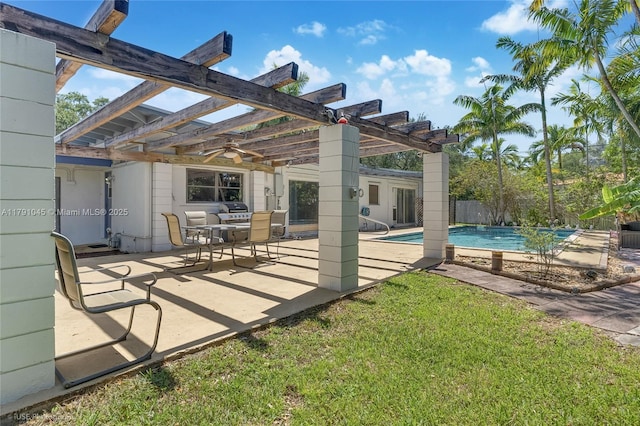rear view of property featuring a pergola, a yard, a patio area, and an outdoor pool
