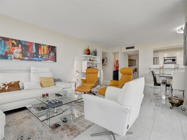 living room featuring light tile patterned flooring and visible vents