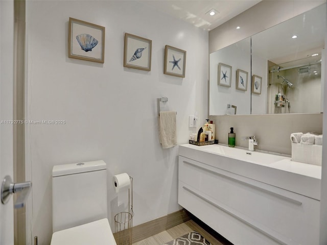 bathroom with walk in shower, vanity, toilet, recessed lighting, and visible vents
