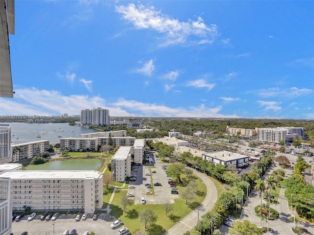 birds eye view of property with a city view and a water view