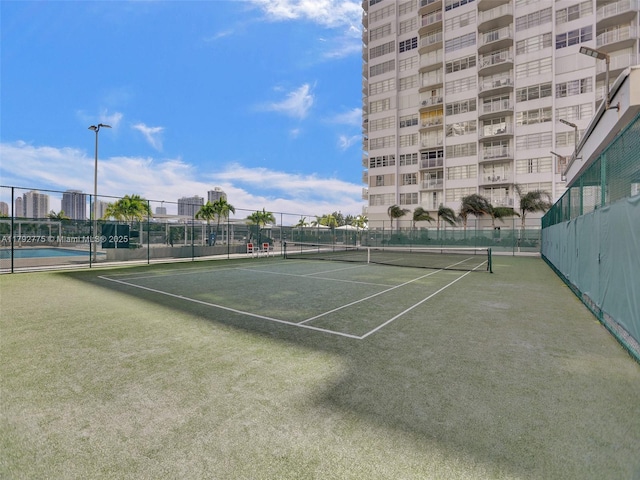 view of sport court featuring fence