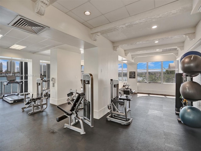 exercise room featuring visible vents, recessed lighting, baseboards, and a drop ceiling