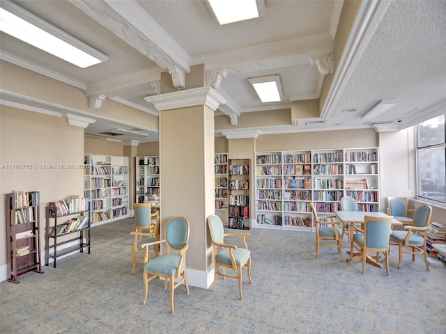 interior space with carpet floors, ornamental molding, and wall of books