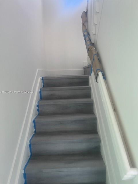 staircase with wood finished floors