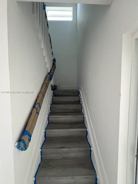 stairway with wood finished floors
