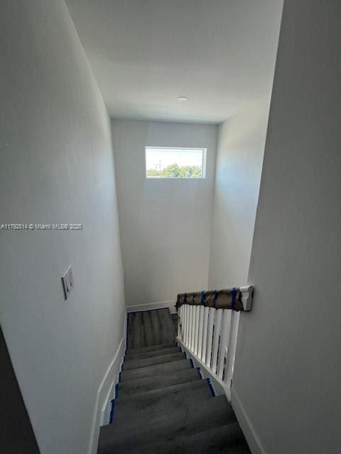 stairs featuring baseboards and wood finished floors