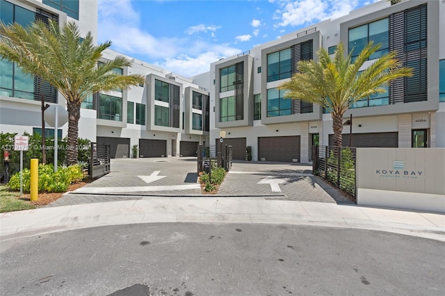 4008 NE 167th St Unit 6, North Miami Beach, FL 33160 - view of building exterior with a garage, driveway, and a residential view