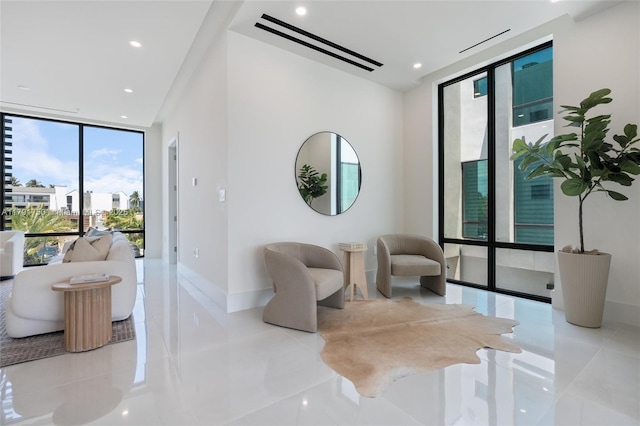 4008 NE 167th St Unit 6, North Miami Beach, FL 33160 - sitting room with recessed lighting, baseboards, tile patterned floors, and a wall of windows