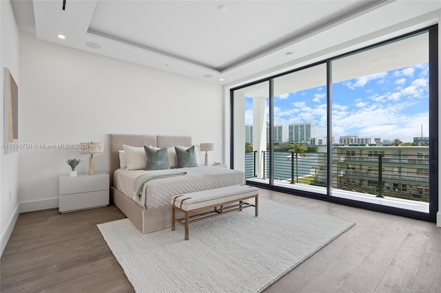 4008 NE 167th St Unit 6, North Miami Beach, FL 33160 - bedroom with access to outside, a wall of windows, a view of city, recessed lighting, and wood finished floors