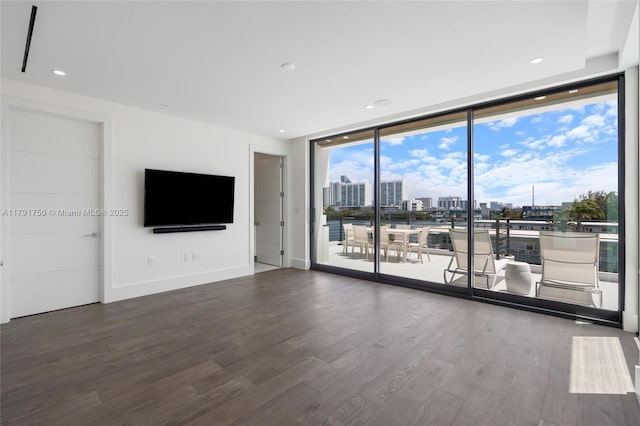 4008 NE 167th St Unit 6, North Miami Beach, FL 33160 - unfurnished living room with recessed lighting, baseboards, floor to ceiling windows, and wood finished floors