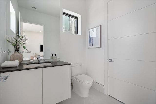 4008 NE 167th St Unit 6, North Miami Beach, FL 33160 - bathroom with toilet, tile patterned floors, visible vents, and vanity