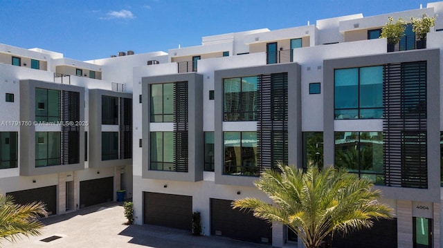 4008 NE 167th St Unit 6, North Miami Beach, FL 33160 - exterior space featuring an attached garage and stucco siding