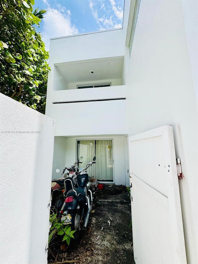 entrance to property featuring stucco siding
