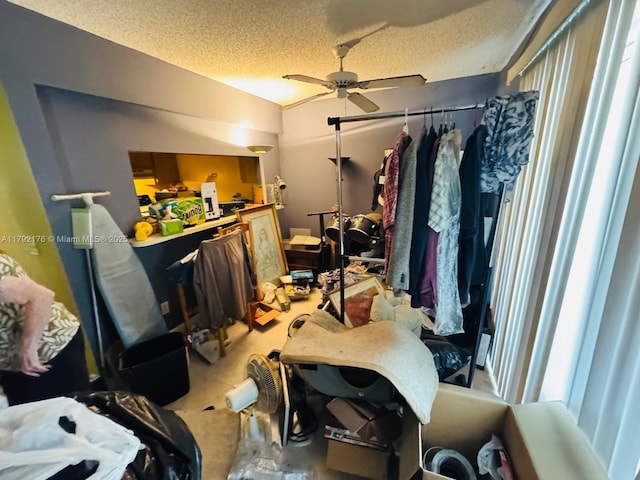 bedroom featuring ceiling fan, vaulted ceiling, and a textured ceiling
