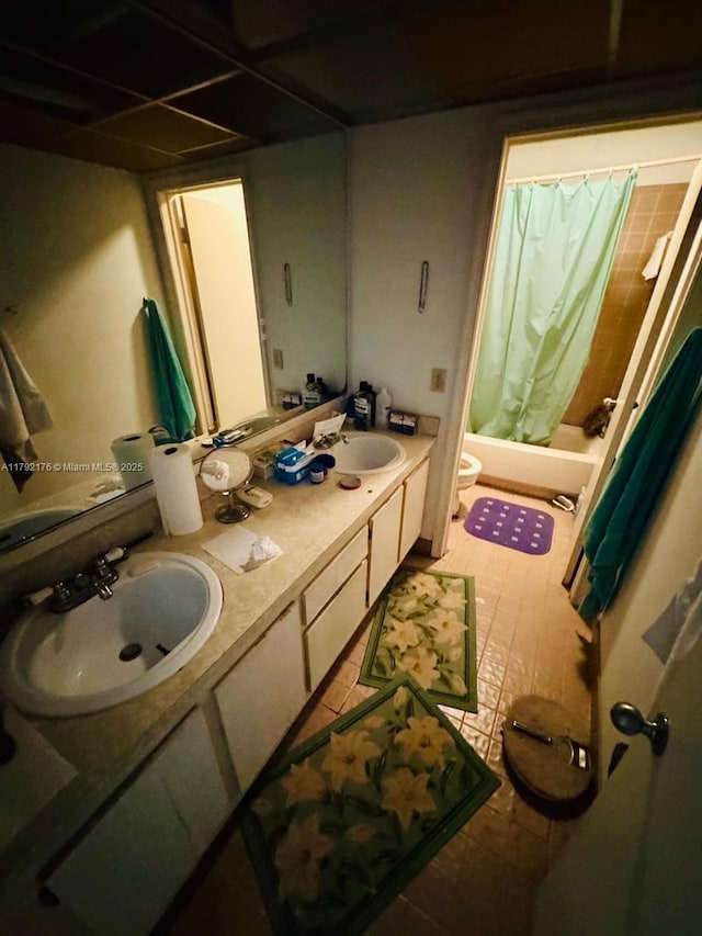 bathroom featuring a sink, shower / bathtub combination with curtain, toilet, and double vanity
