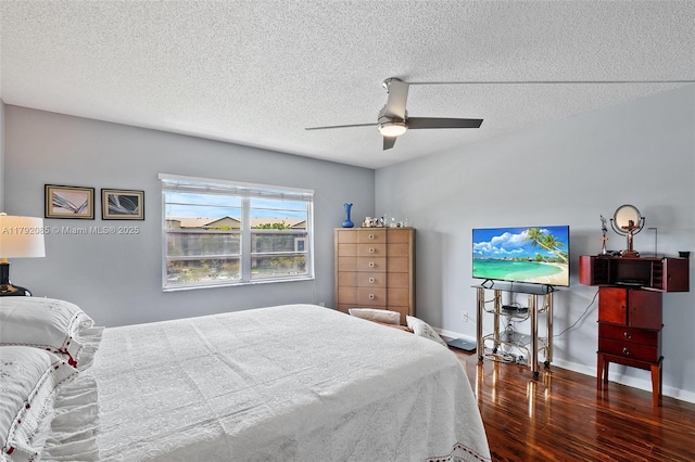 bedroom with baseboards, a ceiling fan, a textured ceiling, and wood finished floors