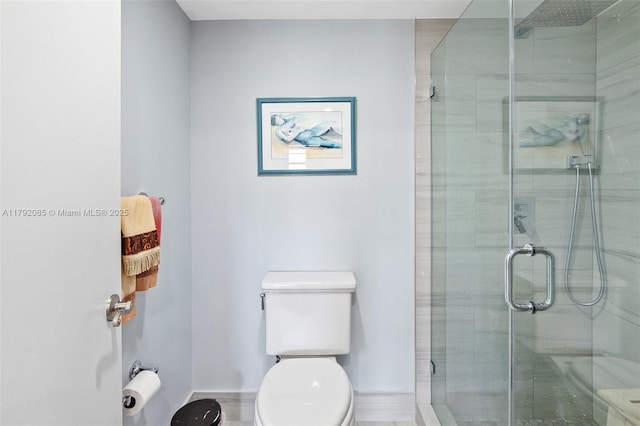 bathroom with a stall shower and toilet
