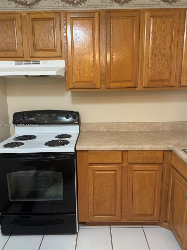 2900 N Pine Island Rd Unit 307, Sunrise, FL 33322 - kitchen with under cabinet range hood, brown cabinets, light countertops, and electric range oven