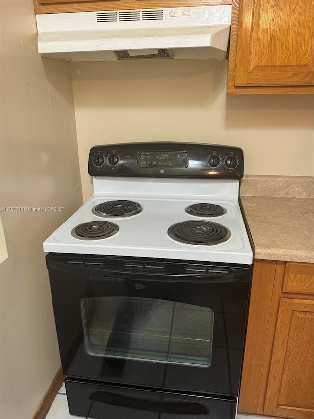2900 N Pine Island Rd Unit 307, Sunrise, FL 33322 - details with light countertops, under cabinet range hood, black electric range oven, and brown cabinets