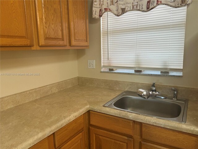 2900 N Pine Island Rd Unit 307, Sunrise, FL 33322 - kitchen with a sink, light countertops, and brown cabinets
