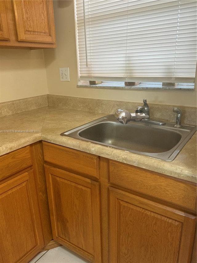 2900 N Pine Island Rd Unit 307, Sunrise, FL 33322 - kitchen featuring a sink, brown cabinets, and light countertops