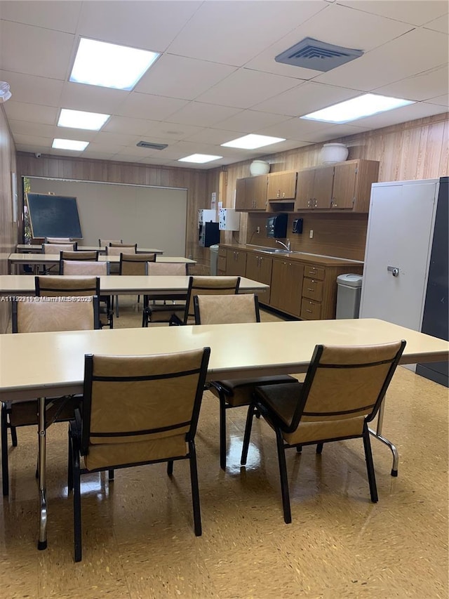 2900 N Pine Island Rd Unit 307, Sunrise, FL 33322 - dining room featuring visible vents, a paneled ceiling, wooden walls, and light floors