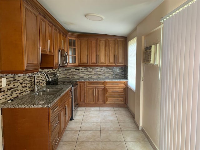 2381 SW 7th St, Miami, FL 33135 - kitchen featuring stainless steel appliances, brown cabinets, backsplash, and glass insert cabinets