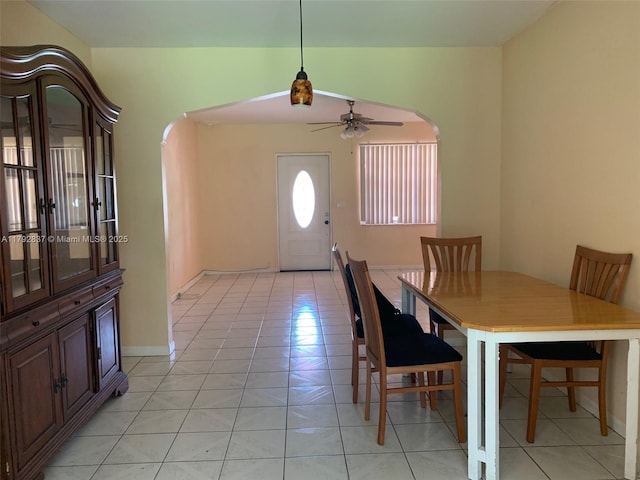2381 SW 7th St, Miami, FL 33135 - dining room with arched walkways, ceiling fan, and light tile patterned floors