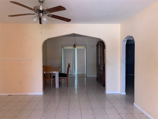 2381 SW 7th St, Miami, FL 33135 - empty room featuring arched walkways, ceiling fan, and light tile patterned floors