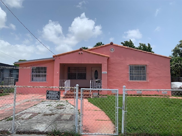 2381 SW 7th St, Miami, FL 33135 - view of front of home featuring a gate, a fenced front yard, stucco siding, and covered porch