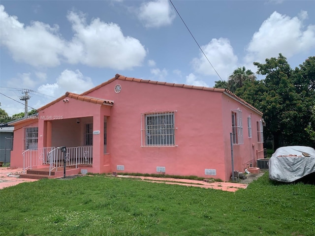 2381 SW 7th St, Miami, FL 33135 - mediterranean / spanish-style house featuring a front lawn, stucco siding, a tiled roof, and crawl space